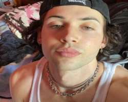 He has piercing in both of his ears and also loves to wear thick chains on his neck.